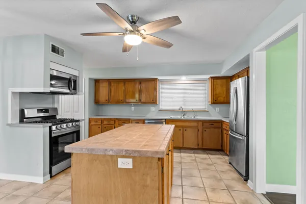 a kitchen with a stove top oven and cabinets