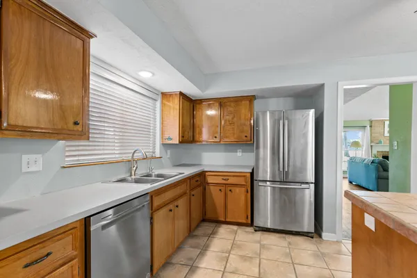 a large kitchen with stainless steel appliances granite countertop a stove and a sink