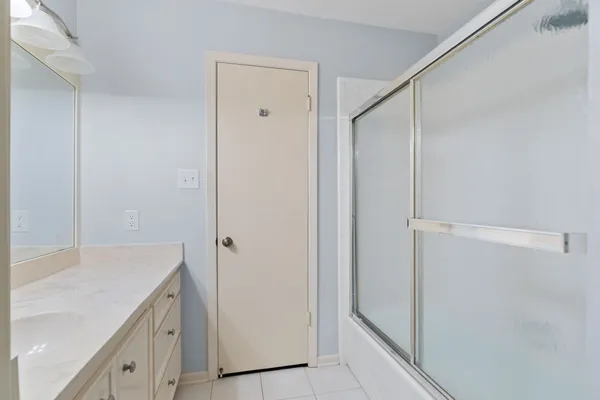 a bathroom with a double vanity sink toilet and shower