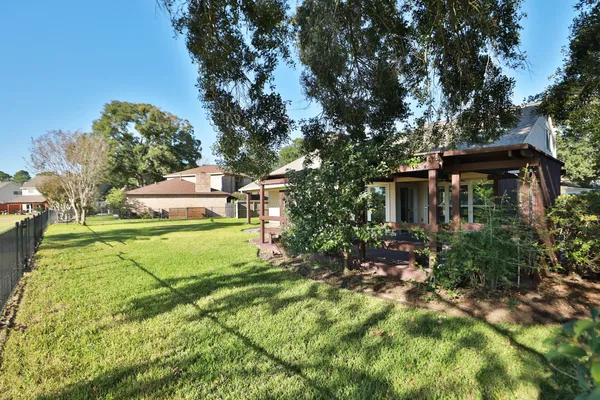 a view of a house with a yard and sitting area
