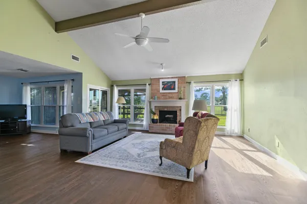 a living room with furniture flat screen tv and a fireplace