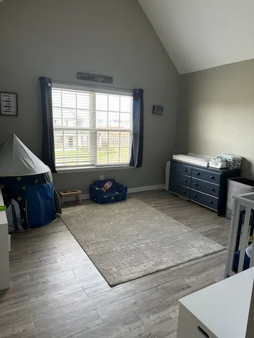 a spacious bedroom with a bed and a window