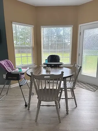 a view of a dining room with furniture window and outside view