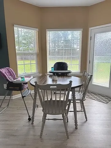 a view of a dining room with furniture window and outside view