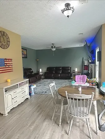 a kitchen with a table chairs stove and cabinets