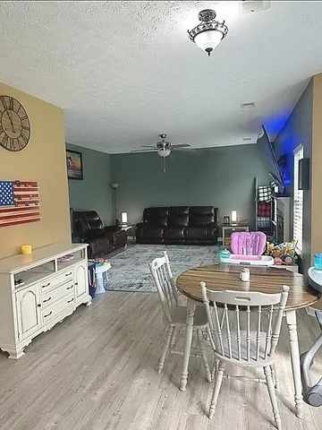 a kitchen with a table chairs stove and cabinets