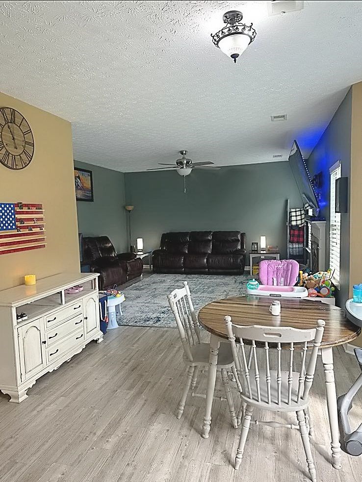 26 Apache Trail Fort Mitchell, AL 36856 - Photo 6 of 18 a kitchen with a table chairs stove and cabinets