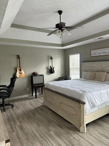 a bedroom with a bed and a chandelier