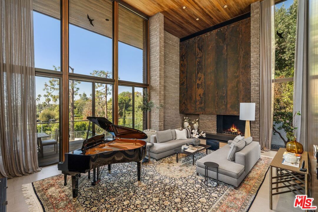 1005 Elden Way Beverly Hills, CA 90210 - Photo 13 of 62 a living room with furniture and a large window