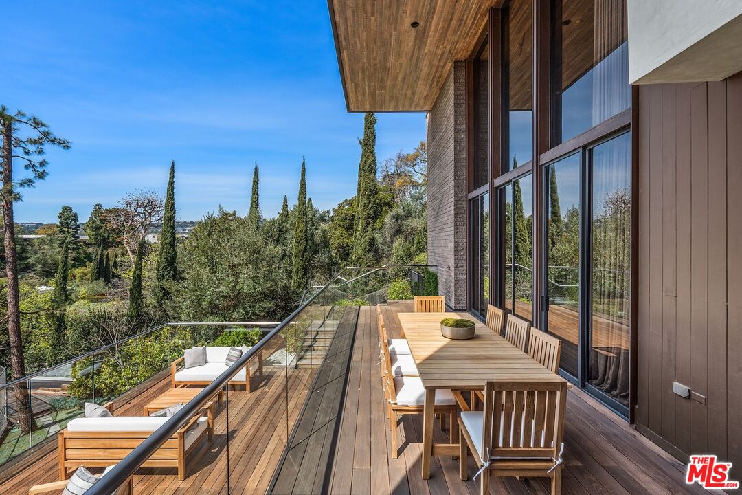 1005 Elden Way Beverly Hills, CA 90210 - Photo 18 of 62 a view of balcony with wooden floor and outdoor seating