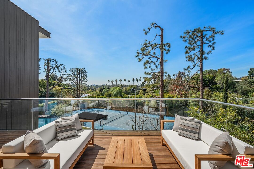 1005 Elden Way Beverly Hills, CA 90210 - Photo 21 of 62 a view of a balcony with wooden floor and outdoor seating