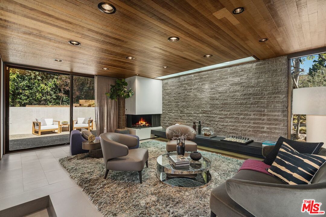 1005 Elden Way Beverly Hills, CA 90210 - Photo 25 of 62 a living room with furniture and a floor to ceiling window