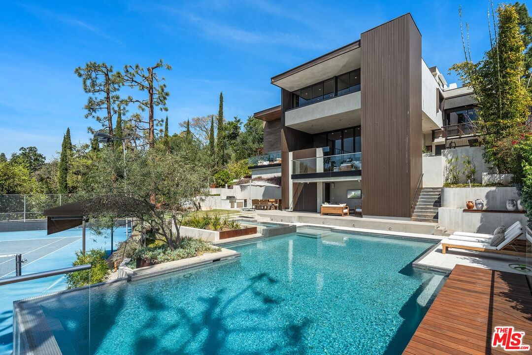 1005 Elden Way Beverly Hills, CA 90210 - Photo 3 of 62 a swimming pool with outdoor seating and yard