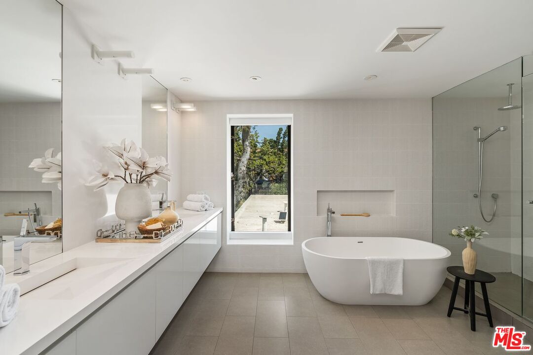 1005 Elden Way Beverly Hills, CA 90210 - Photo 39 of 62 a bathroom with a tub sink and mirror
