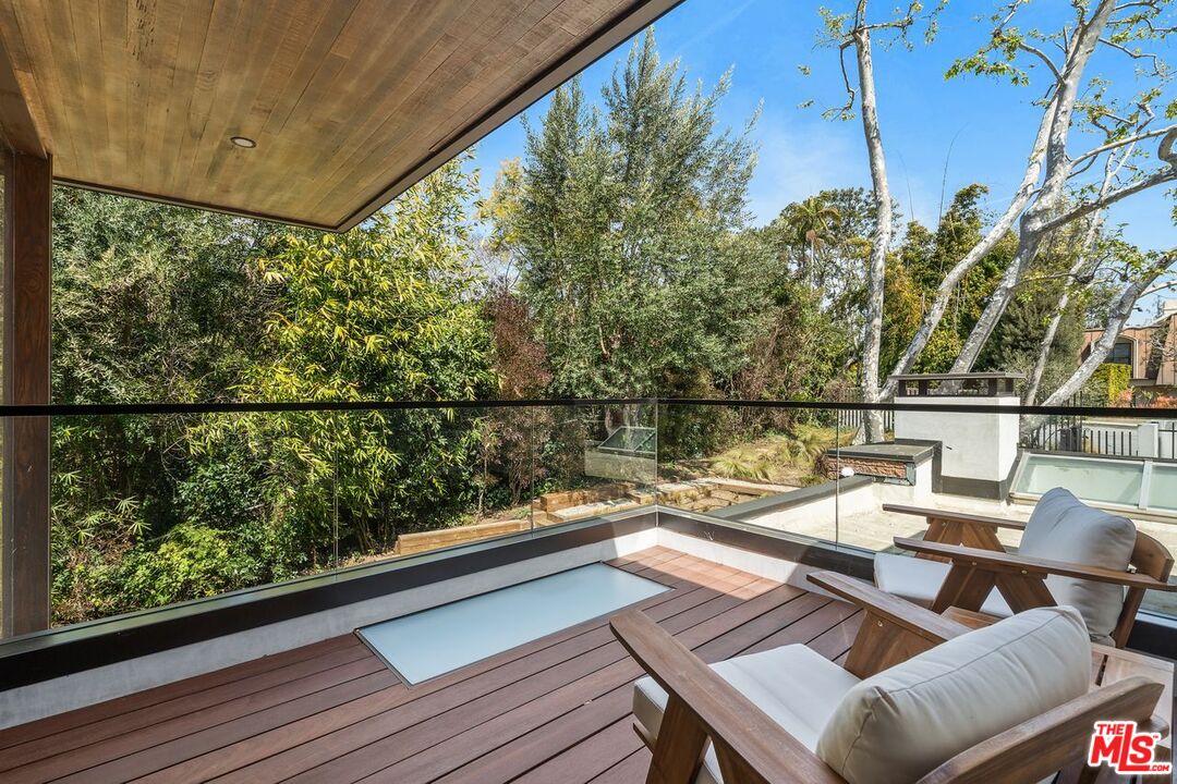 1005 Elden Way Beverly Hills, CA 90210 - Photo 43 of 62 a view of a balcony with wooden floor and outdoor seating