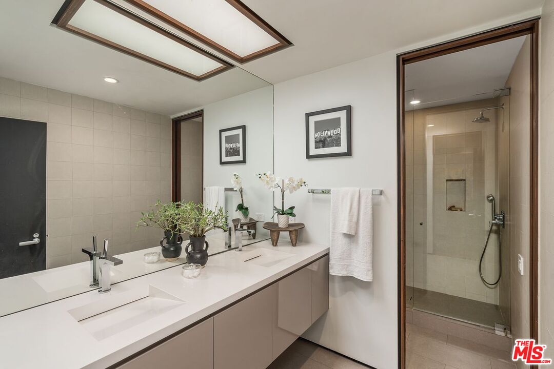 1005 Elden Way Beverly Hills, CA 90210 - Photo 45 of 62 a bathroom with a sink and mirror