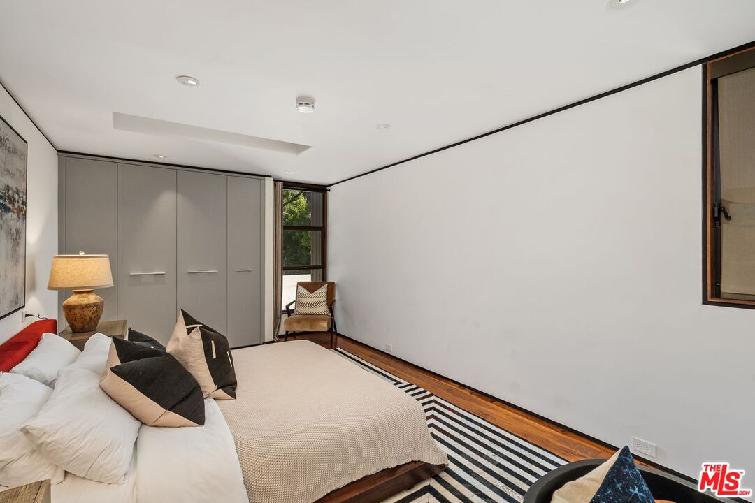1005 Elden Way Beverly Hills, CA 90210 - Photo 49 of 62 a bed room with a bed and a window