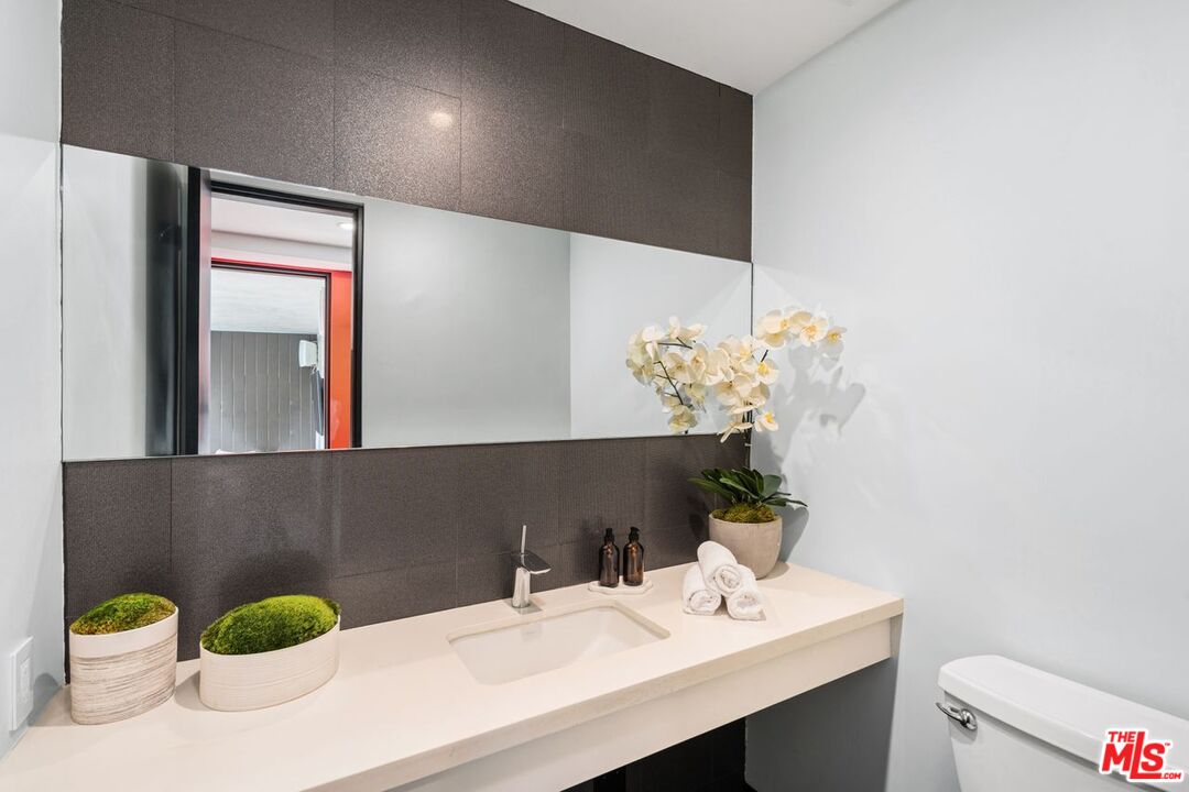 1005 Elden Way Beverly Hills, CA 90210 - Photo 59 of 62 a bathroom with a sink a toilet and mirror