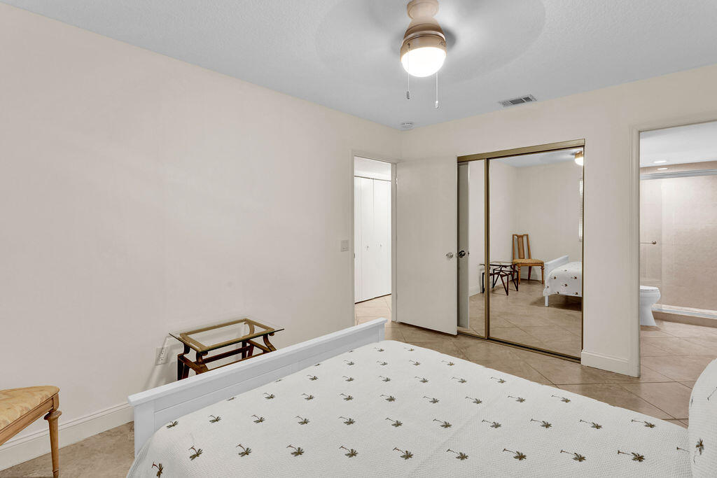 121 Waterside Drive Hypoluxo, FL 33462 - Photo 13 of 22 a bedroom with a bed and a view of bathroom