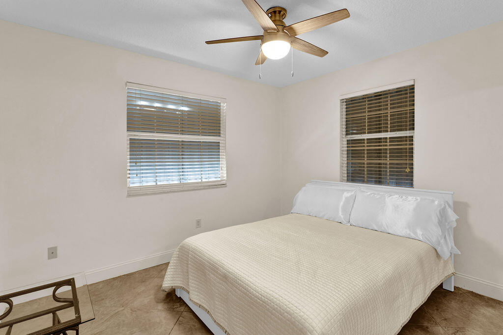 121 Waterside Drive Hypoluxo, FL 33462 - Photo 14 of 22 a bedroom with a bed and window