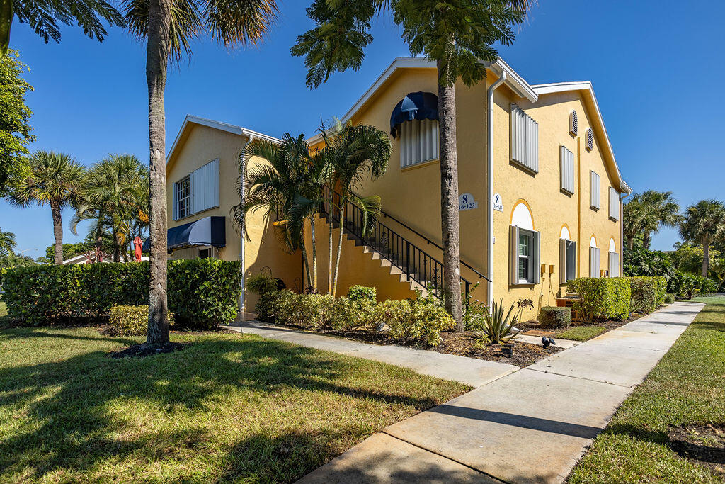 121 Waterside Drive Hypoluxo, FL 33462 - Photo 18 of 22 a front view of a house with a yard