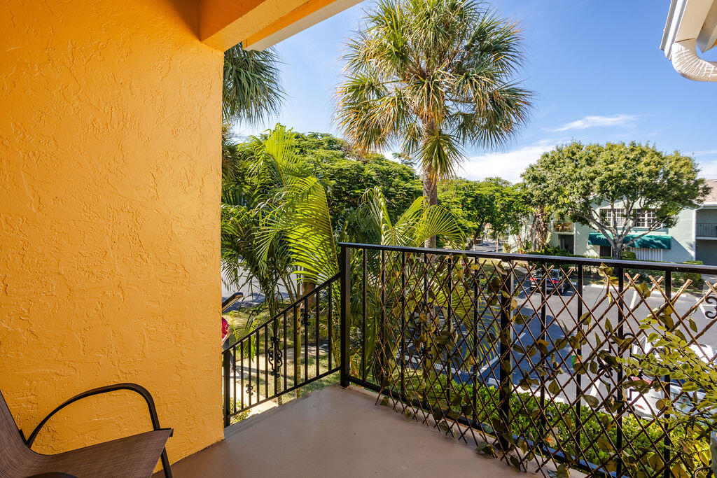 121 Waterside Drive Hypoluxo, FL 33462 - Photo 22 of 22 a balcony with trees in front of it