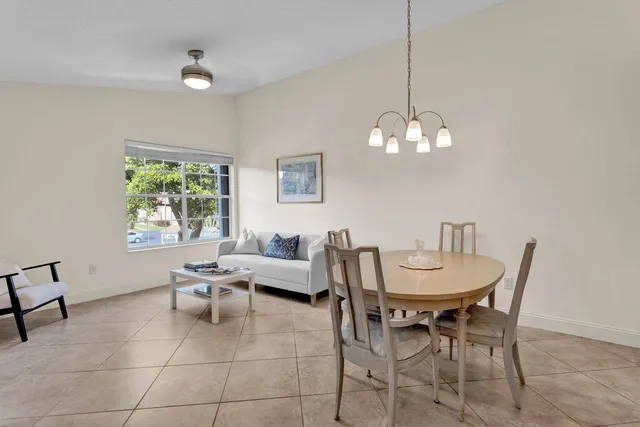a living room with furniture a window and a chandelier