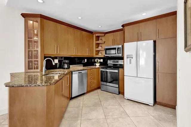 a kitchen with appliances cabinets and a sink