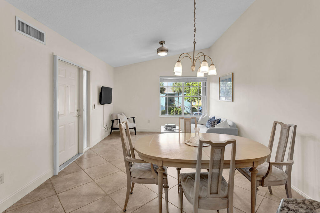 121 Waterside Drive Hypoluxo, FL 33462 - Photo 9 of 22 a dining room with furniture and window