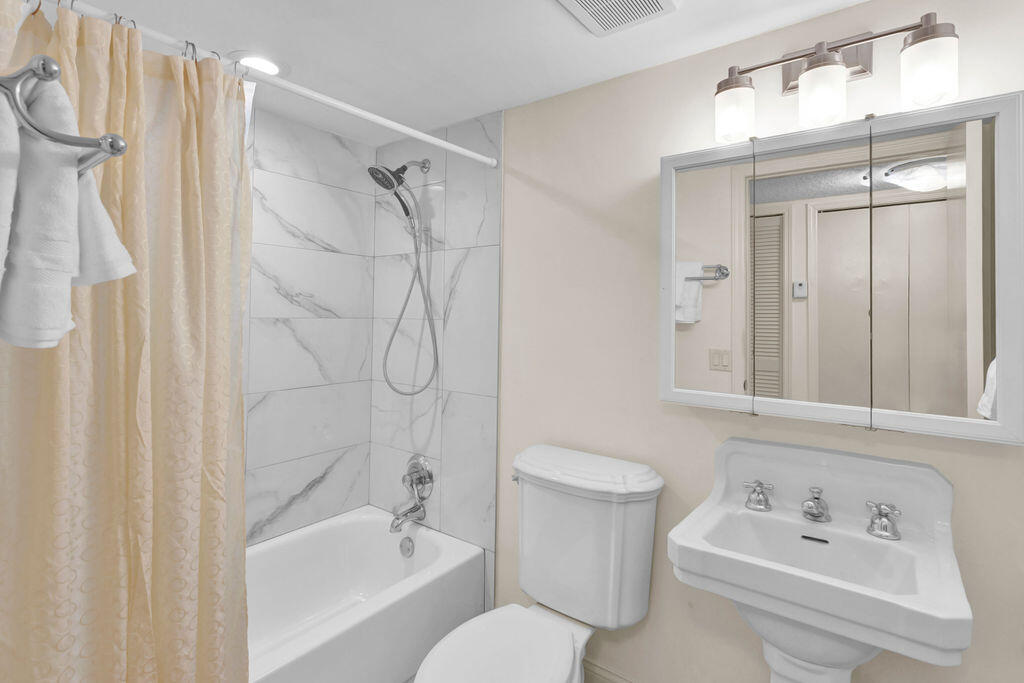 121 Waterside Drive Hypoluxo, FL 33462 - Photo 10 of 22 a bathroom with a bathtub shower sink vanity and toilet