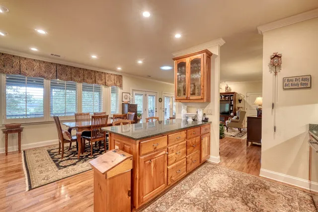 a kitchen with stainless steel appliances granite countertop sink stove top oven and cabinets