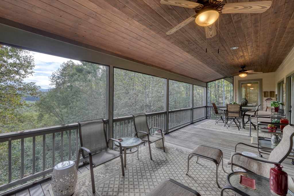 197 Eagles View Road Hayesville, NC 28904 - Photo 15 of 53 a view of a patio with table and chairs with wooden floor and fence