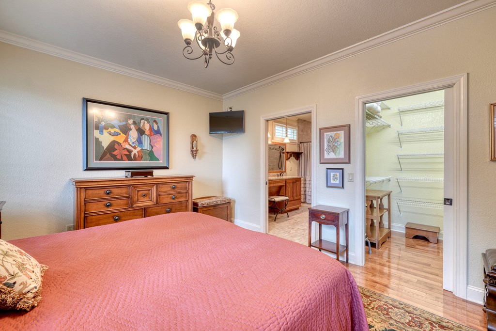 197 Eagles View Road Hayesville, NC 28904 - Photo 18 of 53 a bedroom with a bed and a chandelier