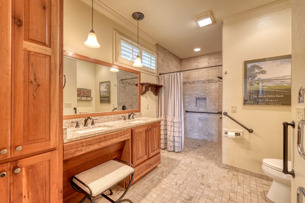 197 Eagles View Road Hayesville, NC 28904 - Photo 19 of 53 a bathroom with a double vanity sink a toilet a mirror and shower