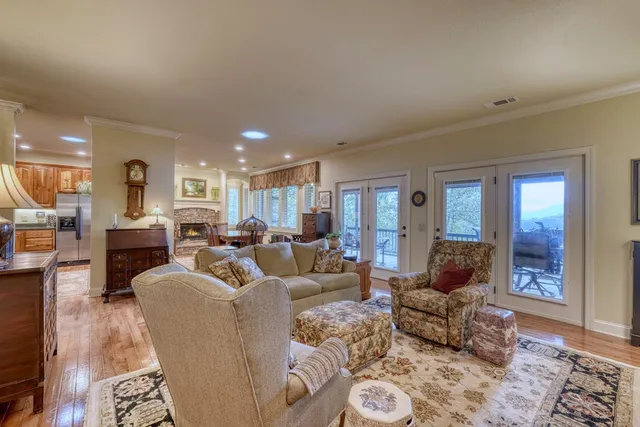 a living room with furniture and a view of kitchen
