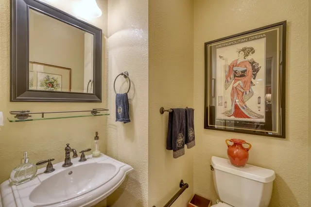 a bathroom with a toilet a sink and a mirror