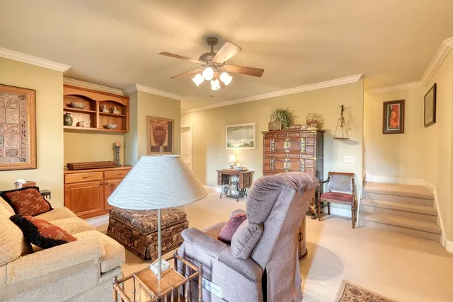 a living room with furniture and a chandelier