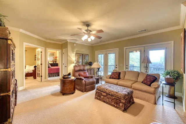 a living room with furniture and a chandelier