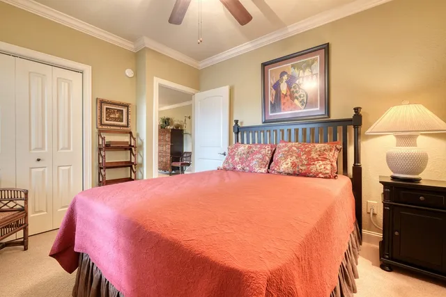 a bedroom with a bed and a lamp on dresser