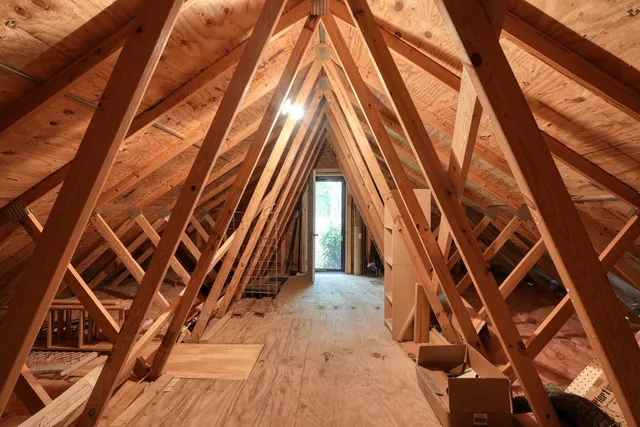a view of a house with a yard and wooden fence