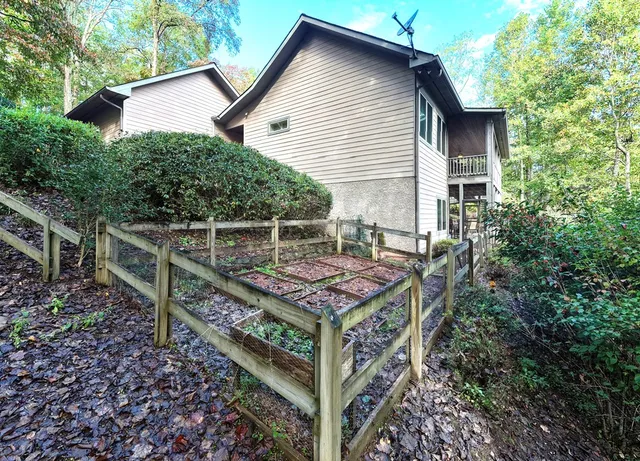 an aerial view of a house with a yard basket ball court and outdoor seating