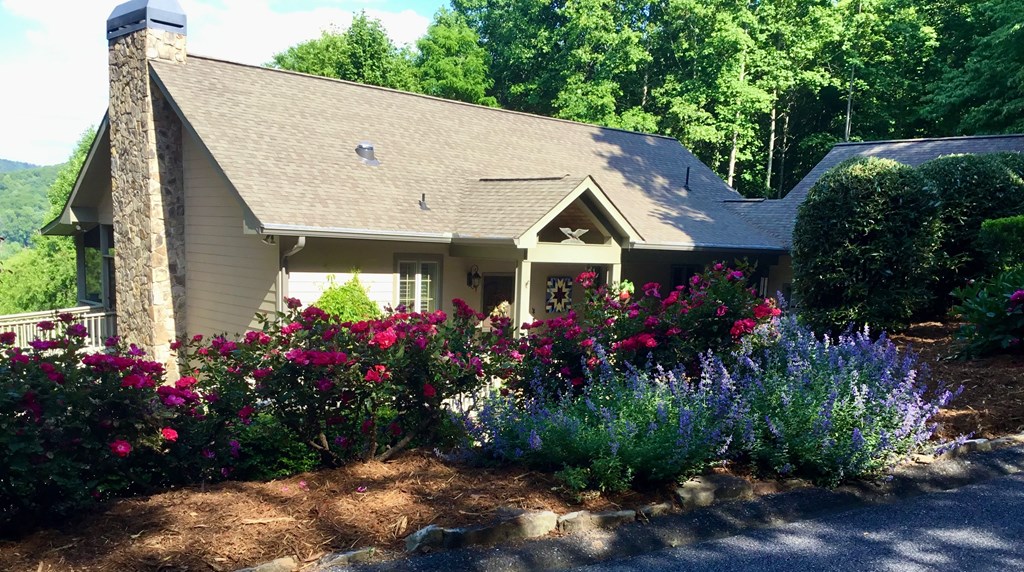 197 Eagles View Road Hayesville, NC 28904 - Photo 51 of 53 a view of a garden with flowers and a fountain