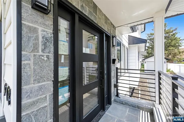 a view of balcony and hallway with wooden floor