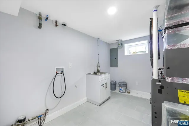 a bathroom with a granite countertop bathtub sink and mirror