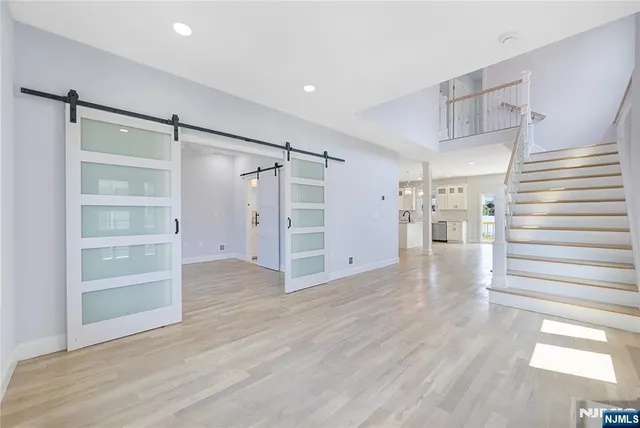 a view of empty room with wooden floor and window