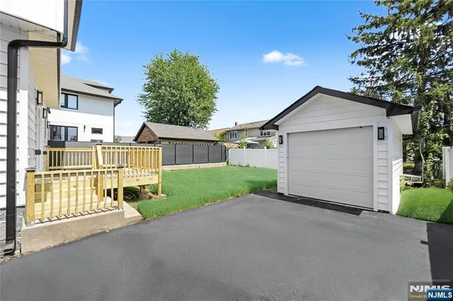 a front view of a house with a garden and garage