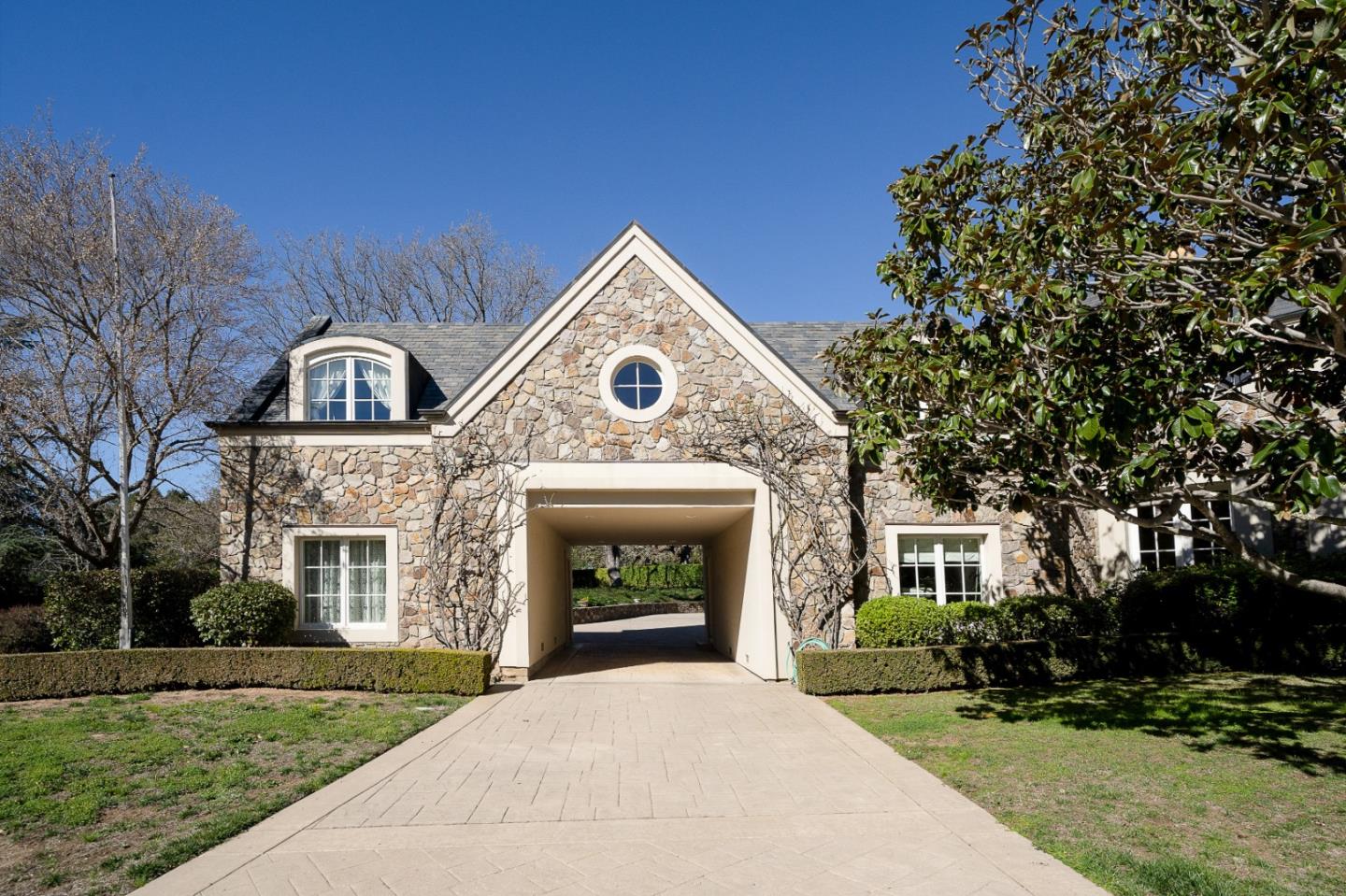 12 Ring Lane Carmel Valley, CA 93924 - Photo 2 of 73 a front view of a house with a garden and trees