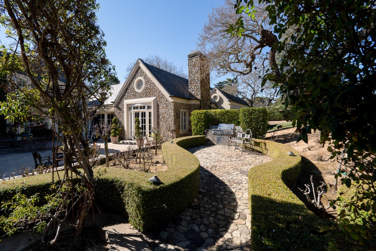 12 Ring Lane Carmel Valley, CA 93924 - Photo 4 of 73 a view of a patio with table and chairs potted plants and large tree