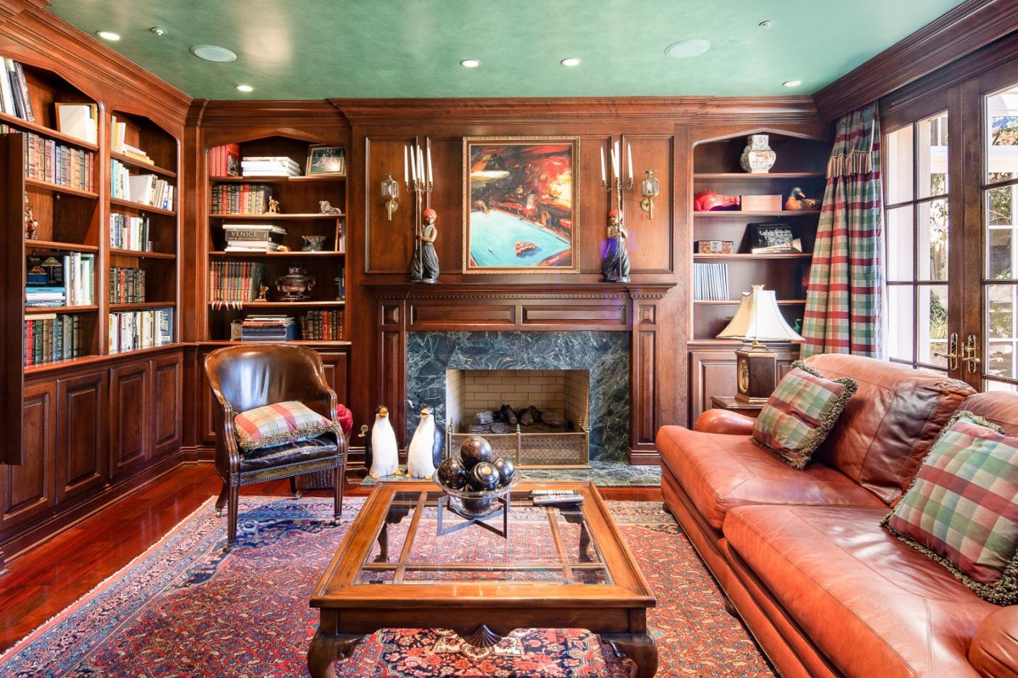12 Ring Lane Carmel Valley, CA 93924 - Photo 32 of 73 a living room with furniture a bookshelf and a fireplace