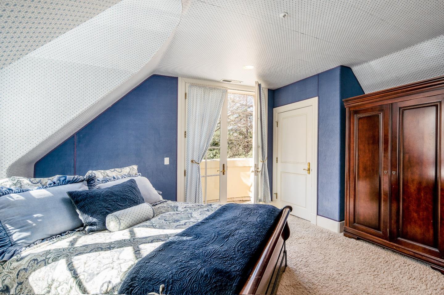 12 Ring Lane Carmel Valley, CA 93924 - Photo 45 of 73 a bedroom with a bed and large windows